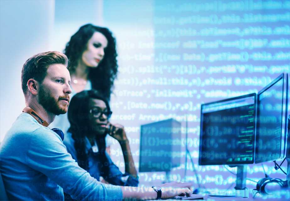 Three employees studying a computer interface